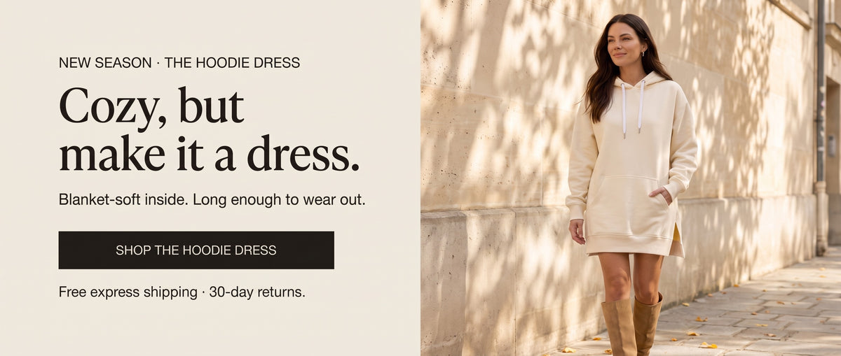 Woman in the cream Junemae oversized hoodie dress with tan knee-high boots. Cozy, but make it a dress.