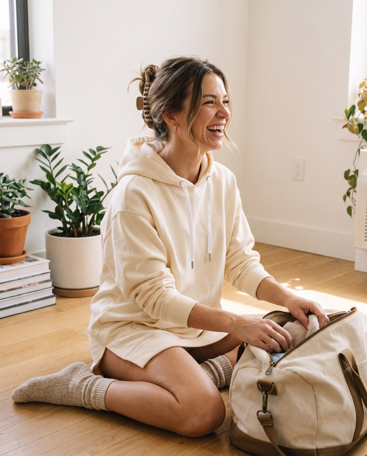 Woman laughing at home in the cream Junemae hoodie dress